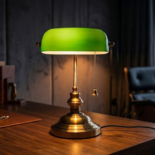 Green desk lamp on a wooden desk with a cityscape view in the background