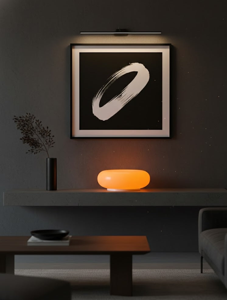 Modern interior with a framed abstract artwork and a glowing orange light on a shelf
