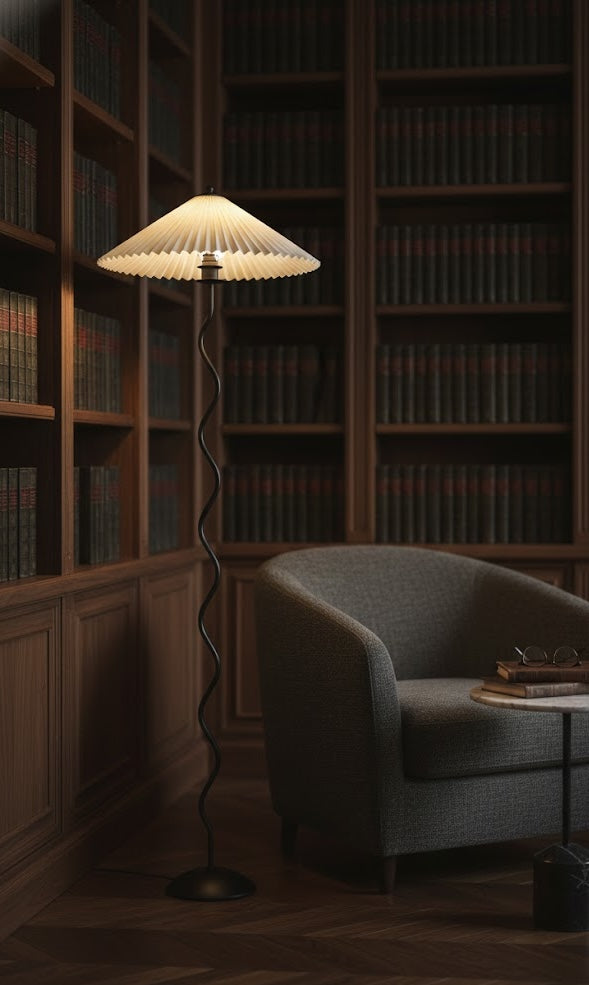 Futuristic lamp in a dimly lit room with bookshelves and a chair