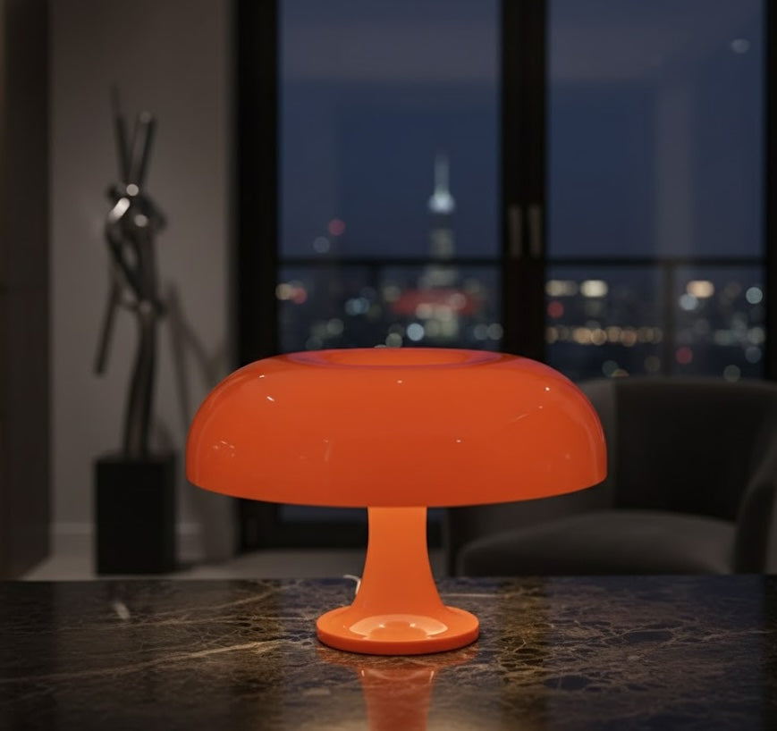 Orange mushroom table lamp on a dark surface with a cityscape in the background