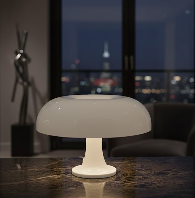 Modern white mushroom table lamp on a reflective surface with a cityscape in the background