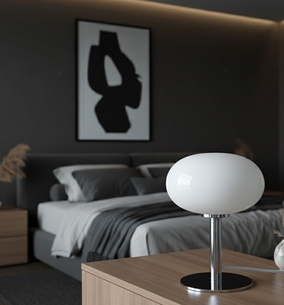 Modern bedroom with a bed, nightstand, and abstract art on the wall