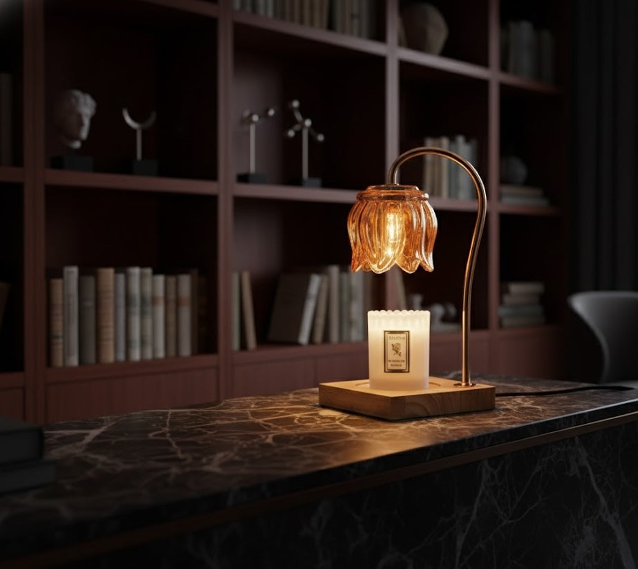 Decorative table lamp candle warmer with a warm glow on a marble surface, with a bookshelf in the background